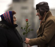 A man offers a rose to a woman to mark International Women's Day in Belgrade