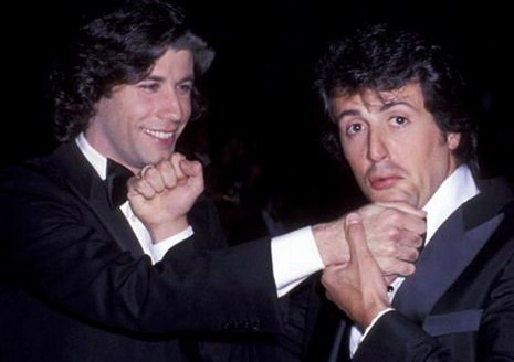 Travolta's got eyes for Stallone. Not shocked.